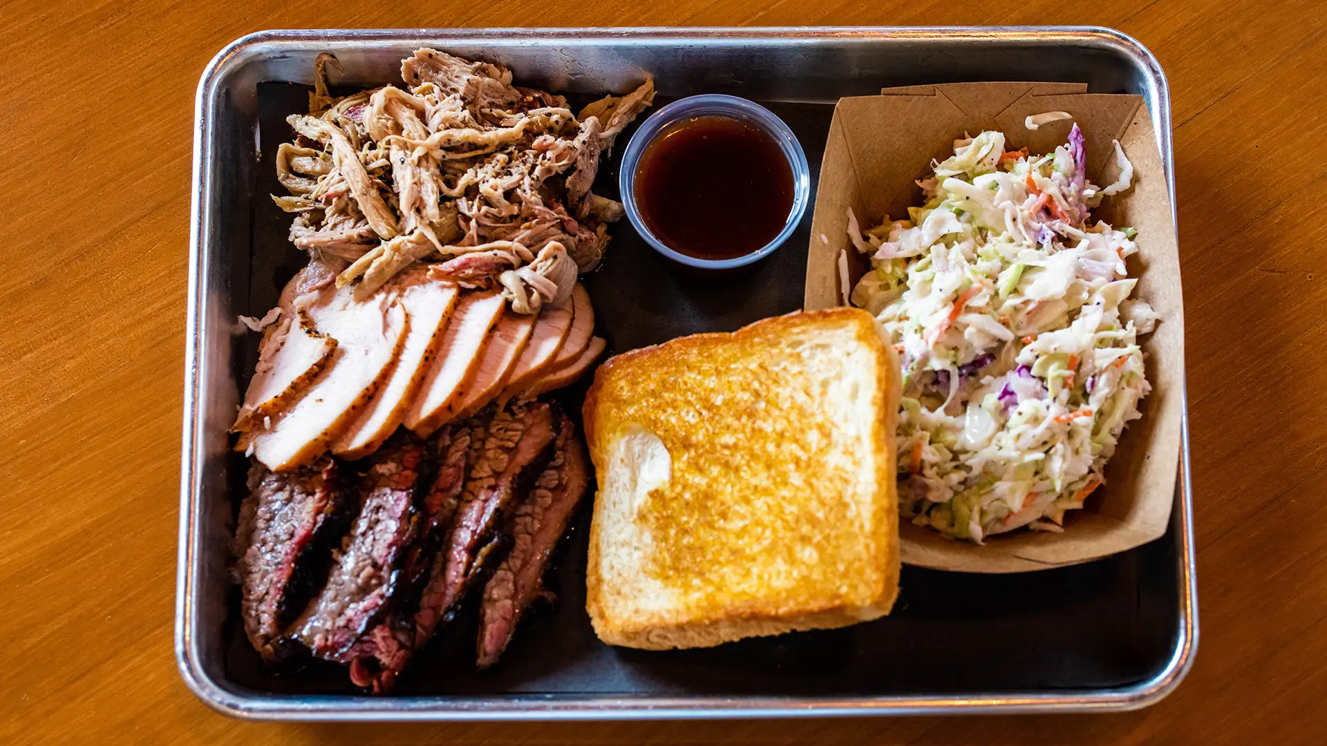 3 meat plate with pulled pork, turkey, brisket, and sides